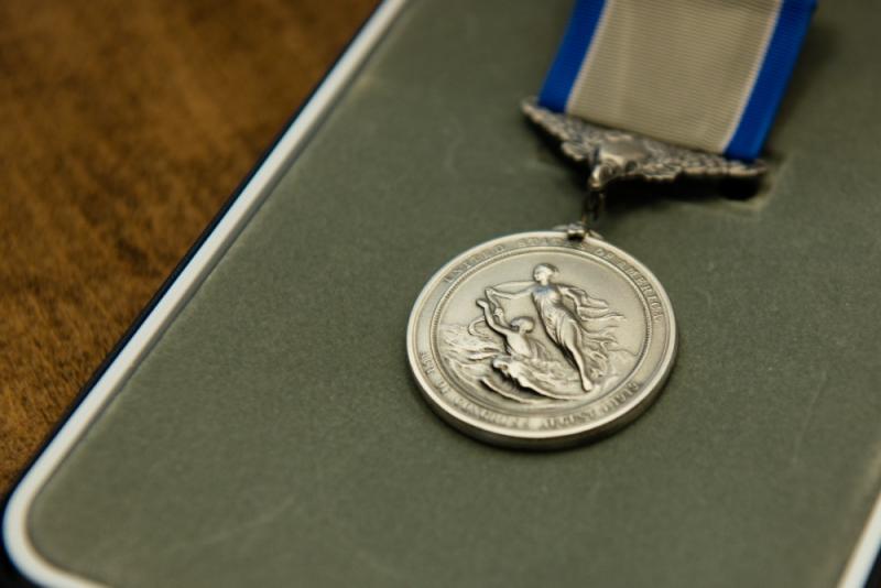 Gov. Paul R. LePage and Rear Adm. Steve Poulin awarded Specialist Corrie Roberts the Silver Lifesaving Medal and Sgt. Matt Talbot the Certificate of Valor in the Maine State House on Tuesday, March 28, 2017. Roberts and Talbot received the awards for actions they took when a 40-foot lobster boat began operating in an uncontrolled manner dangerously close to the rocky shore and local maritime traffic. (U.S. Coast Guard photo by Petty Officer 3rd Class Andrew Barresi)