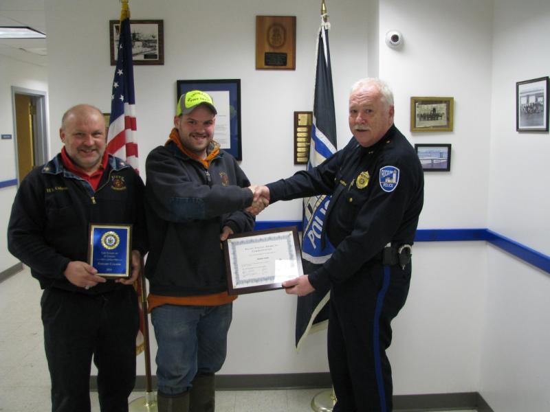 Rockland Police Chief Boucher honored Edward Colson Jr. (left) and Brandon Colson (center) for their life saving actions with administering CPR to a man suffering from a heart attack. (Photo courtesy of Rockland Police Department)