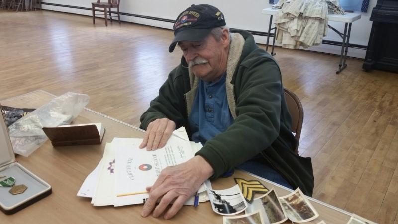 Bob Ogier, who served in the Army’s 9th Infantry Division in Vietnam, shares his numerous certificates of commendation for service on the battlefield. (Photo by Sarah Shepherd)