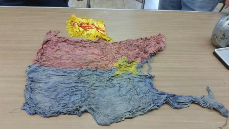 Viet Cong flags from Bob Ogier’s collection. The flags, also known as “flag bombs” were used as decoys. The enemy often rigged the flags with explosives so when US troops took them down, it would set off a charge and kill soldiers. (Photo by Sarah Shepherd)