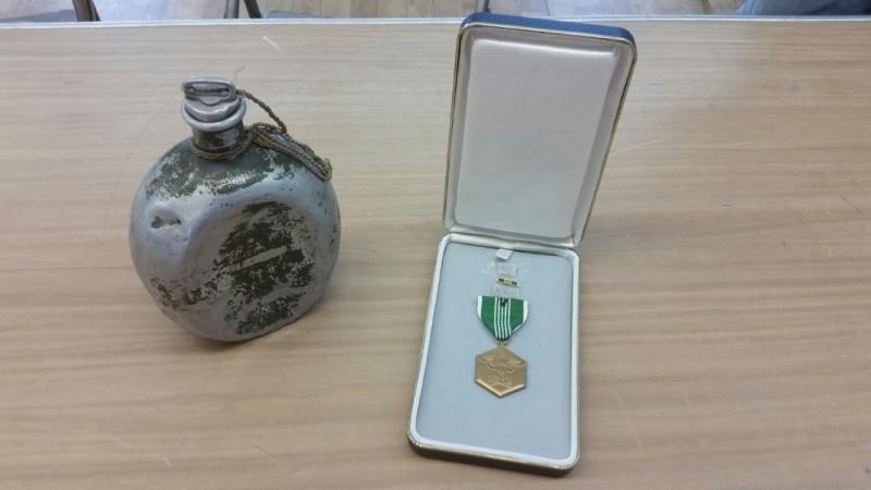 Bob Ogier’s collection of war memorabilia includes a canteen used by a North Vietnamese soldier and his Army Commendation medal. (Photo by Sarah Shepherd)