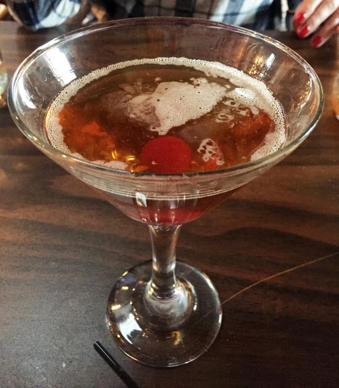 Surprise! I had a manhattan for dessert after brunch. Those are Pamela Lauzau O’Connor’s fingernails in the background. SUZI THAYER/Boothbay Register