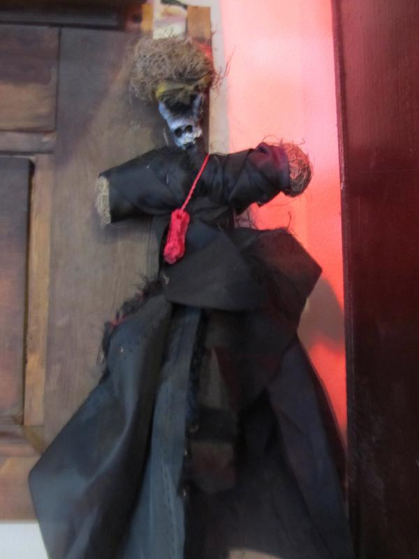 An authentic voodoo doll hangs on the back wall. (Photo by Kay Stephens)