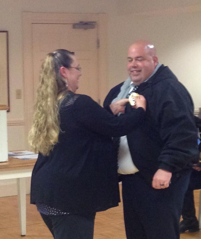 Sgt. Jim Moore is pinned by his wife, Lisa, May 8 at the regularly scheduled Rockport Select Board meeting.