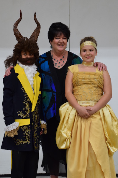 TGS music teacher, Angela Johnson, poses with the Beast (Taygan McAllister) and Belle (Morgan Gehouskey).