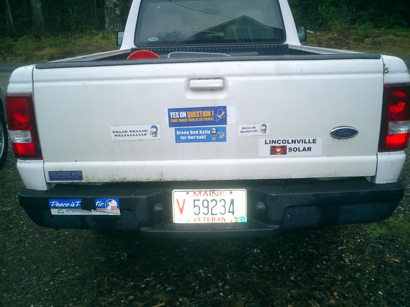 Some people love putting their political persuasions and other enthusiasms on the bumper of their vehicle. We always replenished ours every fall at the Common Ground Fair’s Political Action tent. (Photo by Diane O’Brien) back of truck