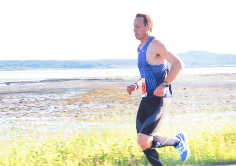 Photographer Dennis Drew aimed directly into the sun to capture marathon winner Robert Ashby near mile two. (Photo by Dennis Drew)
