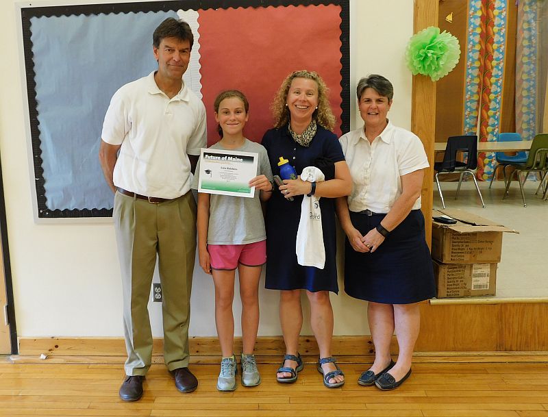 From left, Maine College Circle Director Bob Stuart, fifth-grade winner Erin Robbins and her mother, and Ames Elementary School Principal Lori Smail. (photo by Erica Thoms)
