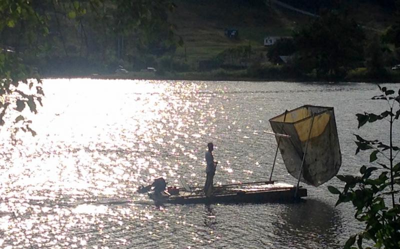 Bill Buchholz, in August 2016, works on cleaning the algae from Hosmer Pond. He obtained an old float from the harbor, and which had been bound for the tinder pile, outfitted it with the scooper, and spent the summer lifting the oxygen-starving algae from the pond. He hauled the green sludge up to his house, and composted it in the woods. (Photo by Lynda Clancy)
