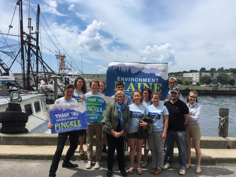 Congresswoman Chellie Pingree poses by the Portland Waterfront after being recognized for her environmental advocacy work by Environment Maine on Monday, July 10. Pictured, left to right: Will Monaco, Seanna Flynn, Henry Dodge, Clare Loughlin, Congresswoman Chellie Pingree, Nick Manning (behind), Abi Bradford, Trisha Poulin, Julia Gesensway, Mathias Burner, John Poulin (behind), and Emily Tucker (Maine Coast Fishermen's Association).