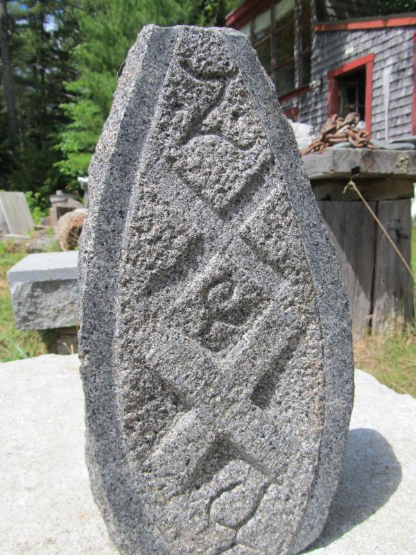 One of his intricate carvings that sits on his property.