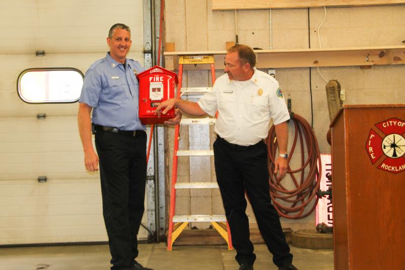 Asst. Chief Elwell (right) presents a retirement gift to Jamie Leo a couple months ago. (Photo courtesy of Rockland Fire/EMS)