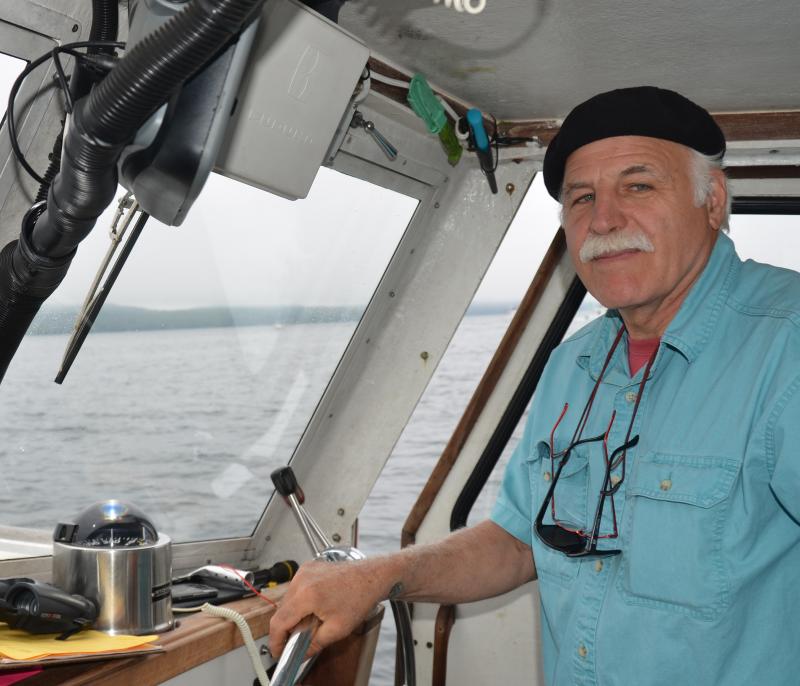 Keith Cafferata at the helm of the Quicksilver. (Photo by Lynda Clancy)
