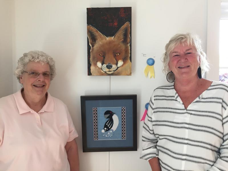 Best in Show and People’s Choice of the juried art show: Sue Mondabaugh, Camden and Julie Cyr, Belfast. (Photo courtesy Carney Doucette)