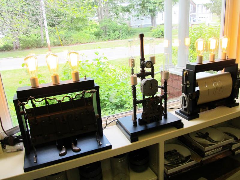 Three steampunk lamps made from salvaged player piano parts, pipefittings, gauges and gears in Tenants Harbor’s store, Stonefish. (Photo by Kay Stephens)