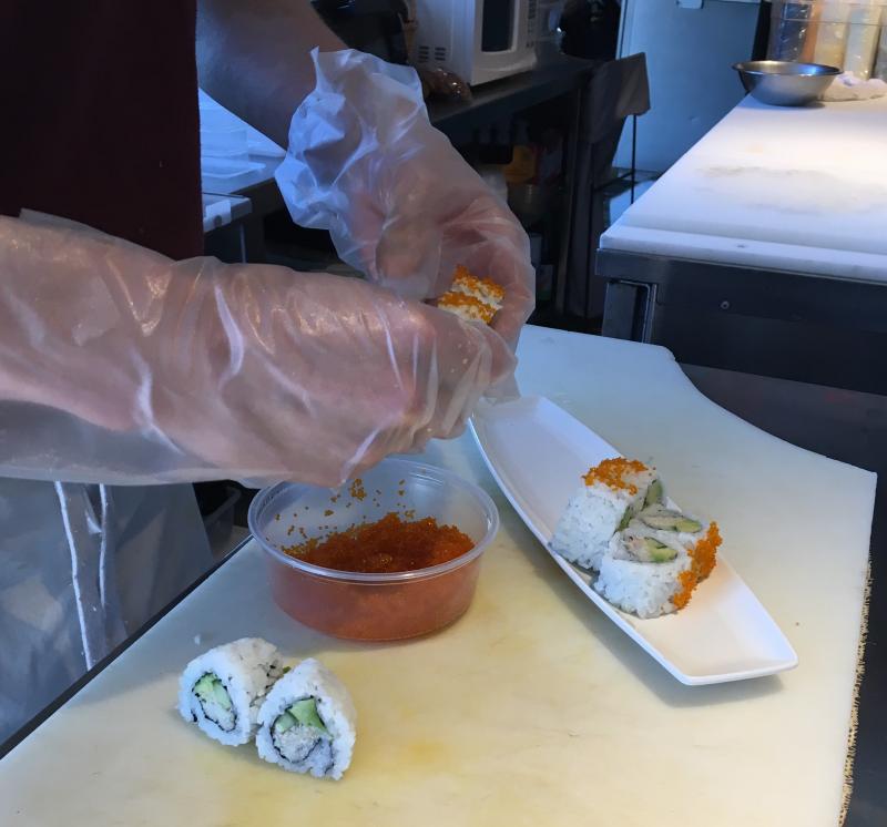 Wendell Thayer demonstrates the fine art of making sushi. SUZI THAYER/Boothbay Register