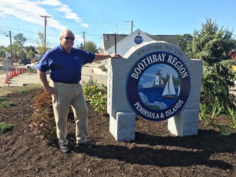 Paul Coulombe with the new sign he had made for the entrance to the Boothbay Harbor area. SUZI THAYER/Boothbay Register