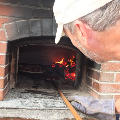 Ken Paquin checks his pies