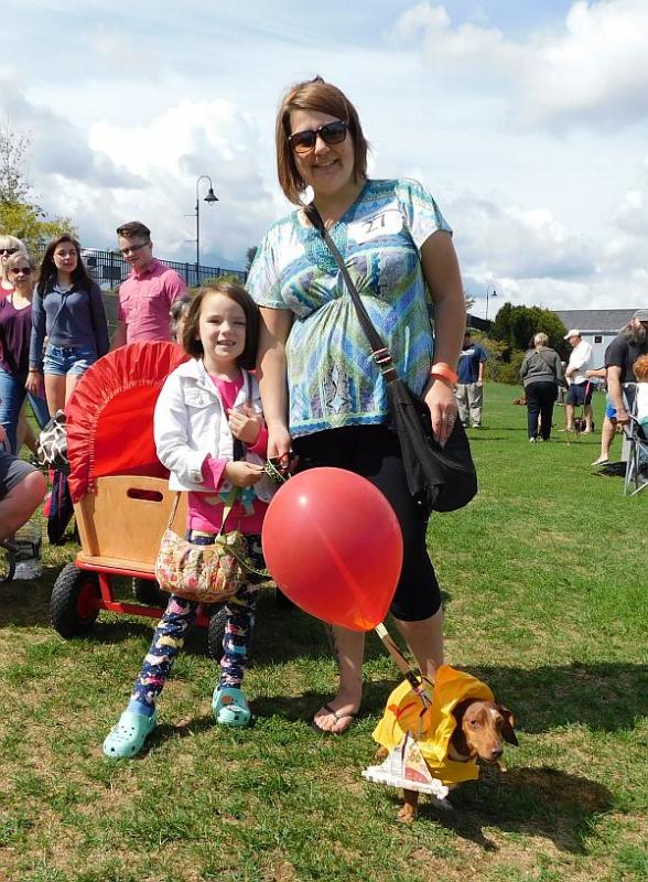 Brandie Cardenas, of Bucksport, poses with her dachshund Dr. Frank-N-Furter and a young friend. (photo by Erica Thoms)