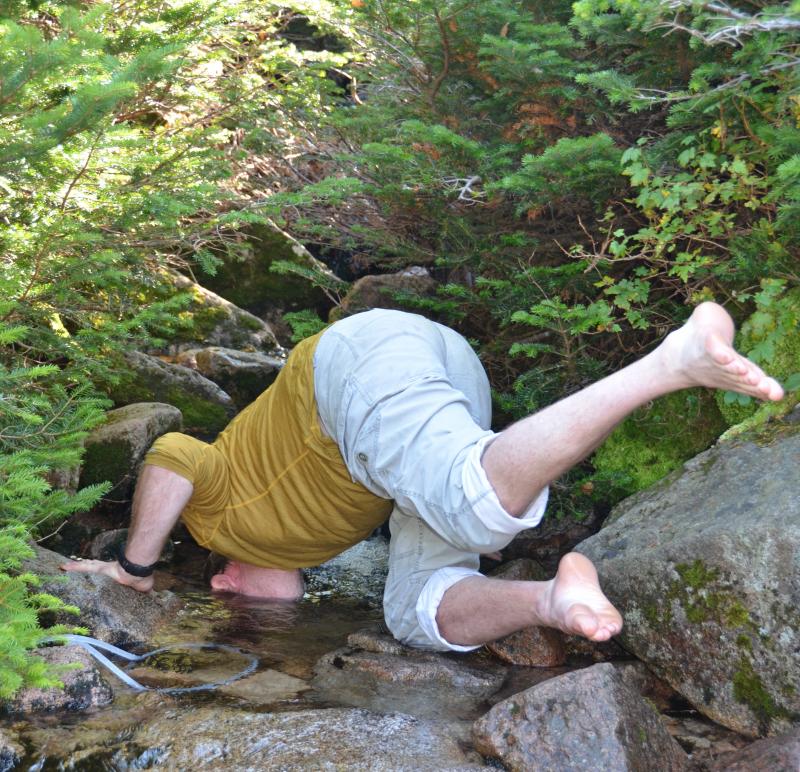Roy Curtis dunks his head into the Saddle Trail stream. (Photo by Lynda Clancy)