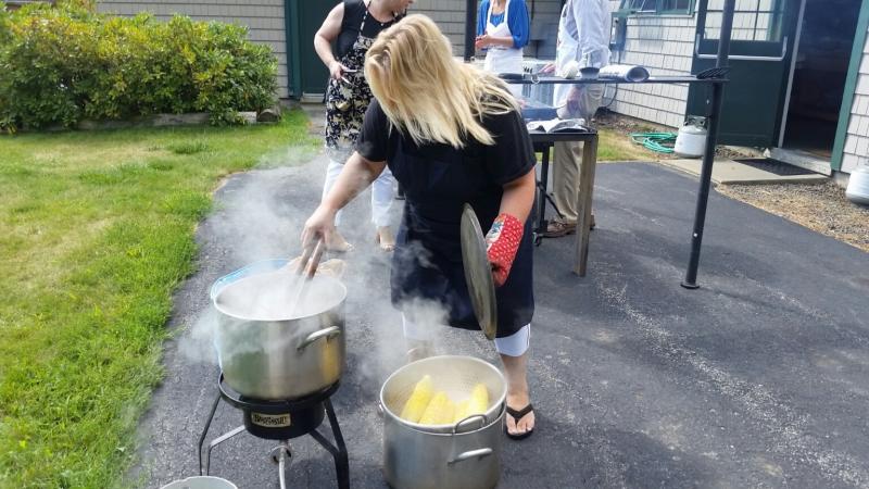 Cathrin Erskine steaming the corn for the buffet lunch. (Photo by Sarah Shepherd)