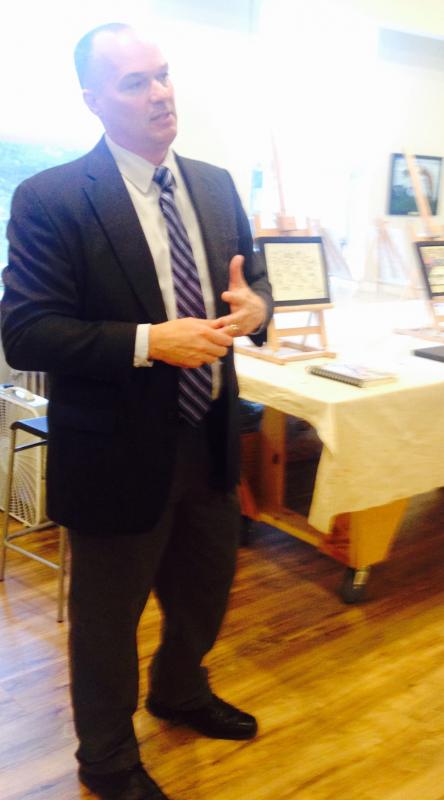 Maine State Prison Warden Randel Liberty speaks at the Art Loft show opening of art made by Maine State Prison inmates.
