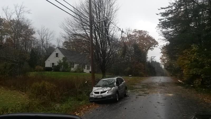 This car traveling the Ducktrap Road in Lincolnville had a tree topple onto it. (Photo courtesy Mike Eugley)