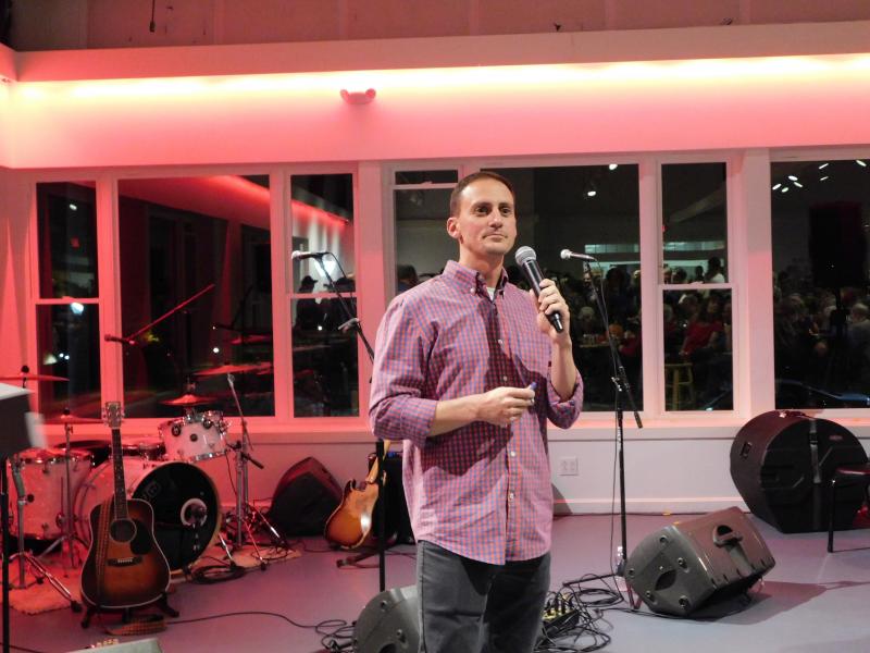 Colby Horne reads raffle ticket numbers. (photo by Erica Thoms)