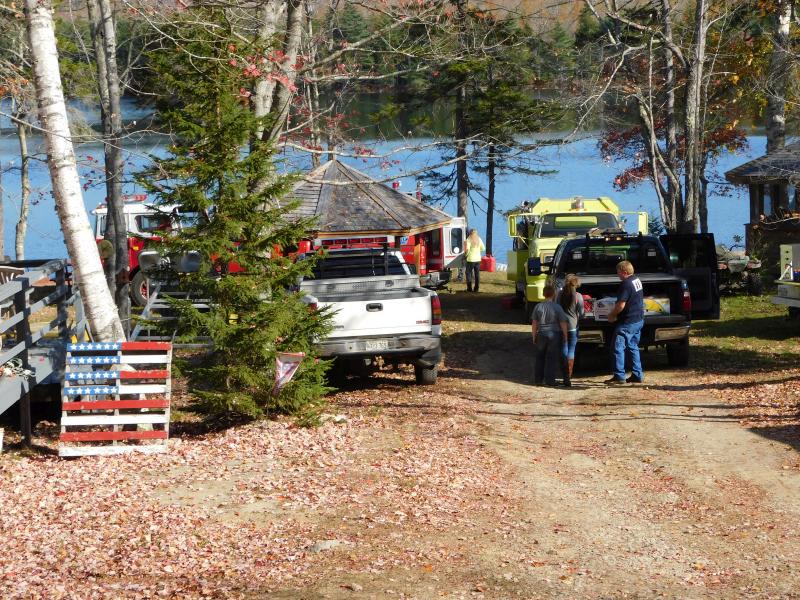 Fire crew on Half Moon Pond access the fire by boat. (photo by Erica Thoms)
