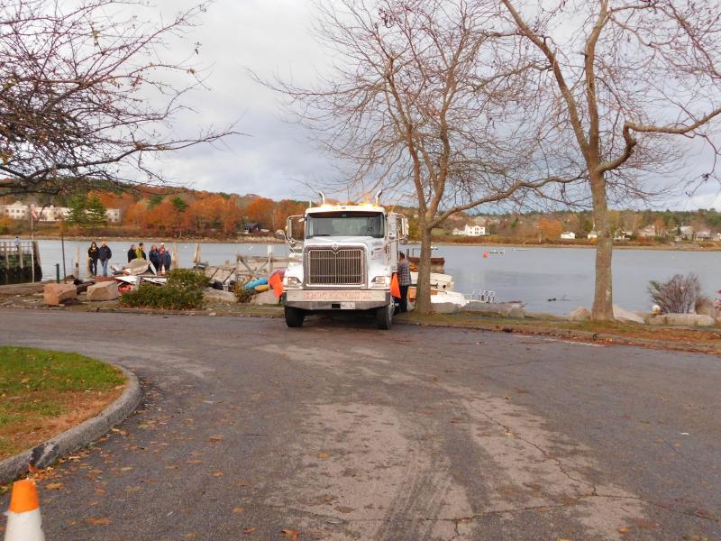 A wrecker crew work to recover pieces of a boat destroyed in the storm. (photo by Erica Thoms)