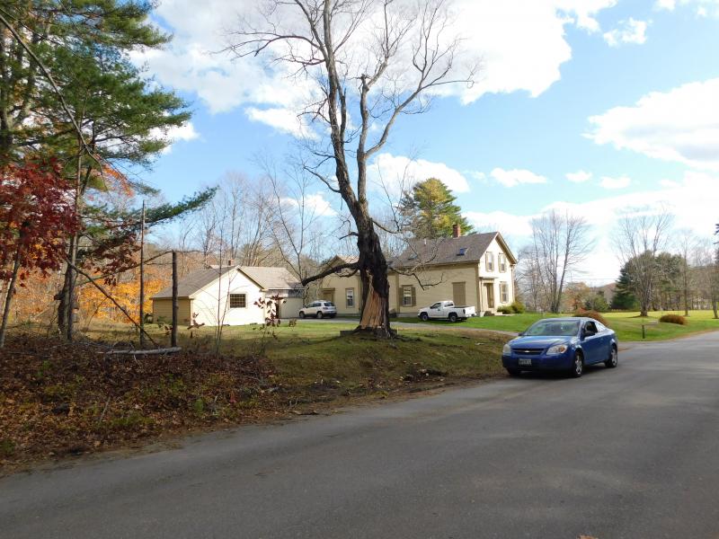 Hall worked to chop up a massive limb that fell from this tree, on Kaler Road in Belfast. (photo by Erica Thoms)
