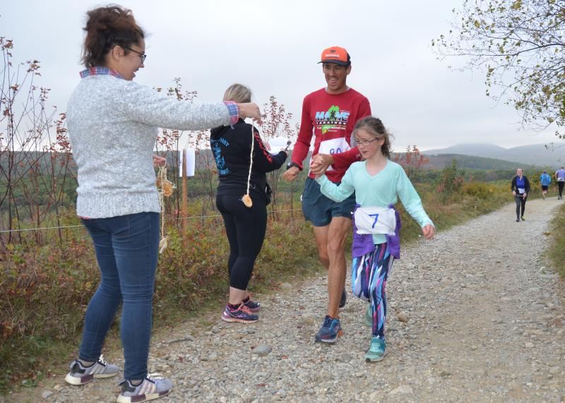 Runners and walkers took to the hills of Rockport Saturday morning, earning handmade medals for completing the first-ever Beach to Beech 5K up the new Connector Trail. (Photo by Lynda Clancy)