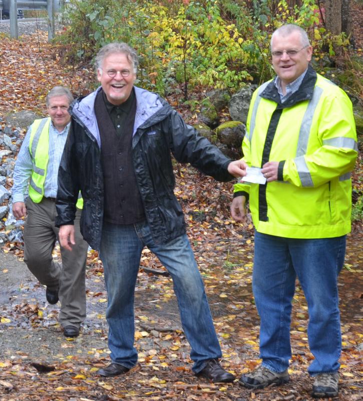 Trout Unlimited’s Dan Daly hands Lincolnville Town Administrator David Kinney the final check for the $208,000 culvert rebuild project. (Photo by Lynda Clancy)