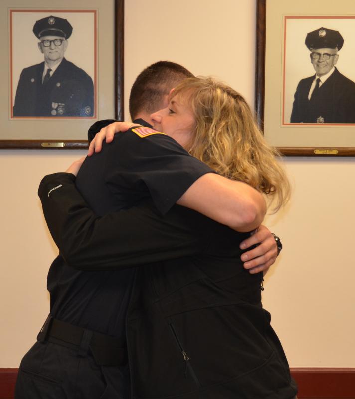 Camden firefighter Isaiah Backiel gets a hug from April Totman, mother of Adin Grey, who was saved by Camden’s first responders in mid-September.