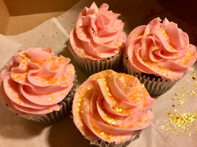 Dark chocolate cupcakes with pink honey buttercream frosting and edible gold sparkles, from Mammy’s Bakery. SUZI THAYER/Boothbay Register