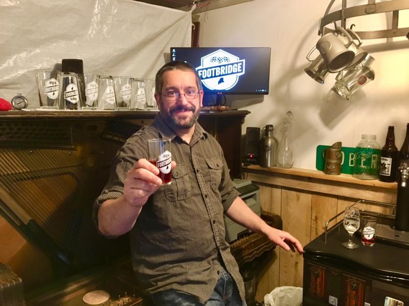 Dan Pangburn with one of the beers he and Nick Ullo have brewed. SUZI THAYER/Boothbay Register