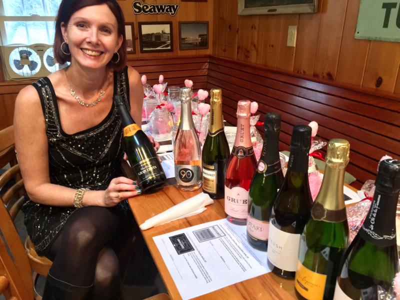 Maia Gosselin gets ready to serve up some elegant bubblies at a wine tasting at the Carriage House in East Boothbay. SUZI THAYER/Boothbay Register