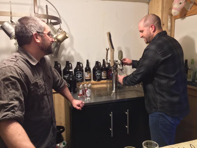 Dan Pangburn, left, and partner Nick Ullo, pour one of their beers on tap. SUZI THAYER/Boothbay Register