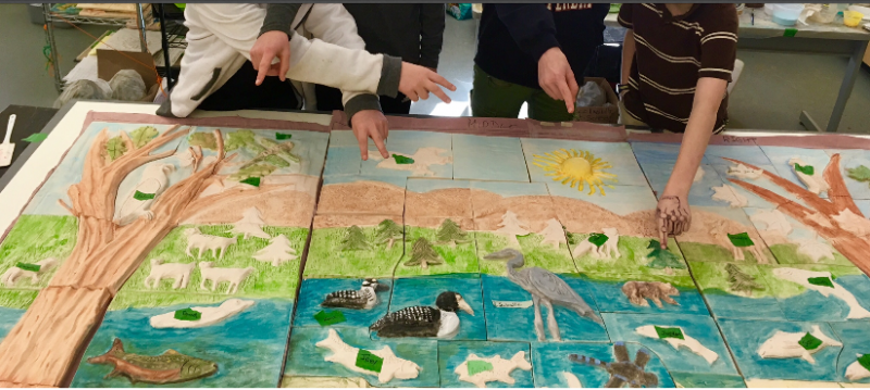Children point to the creature they created on the Megunticook Watershed ceramic mural they’re working on with artist Randy Fein this winter.
Photo by Randy Fein mural