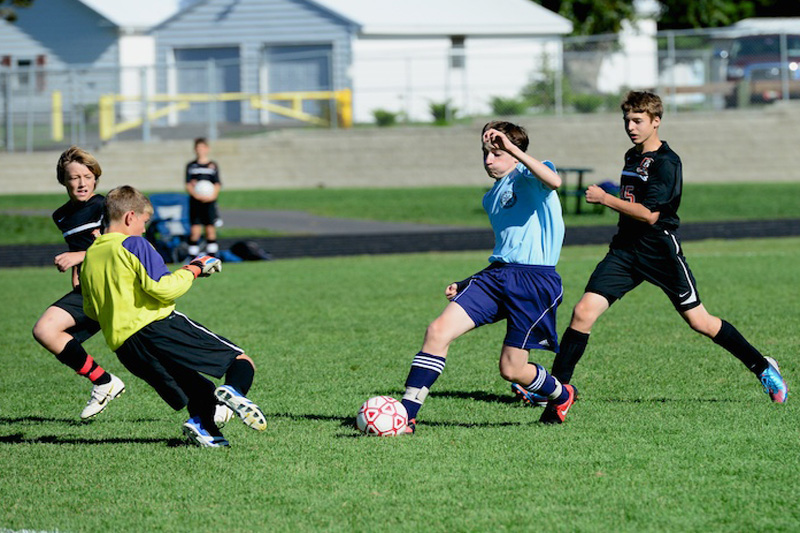 Pen Bay 14U player Morgan Mercier, center, puts a move on the Brewer goalie for a score during a 2012 game in Brewer. (Courtesy Bruce Jordan)