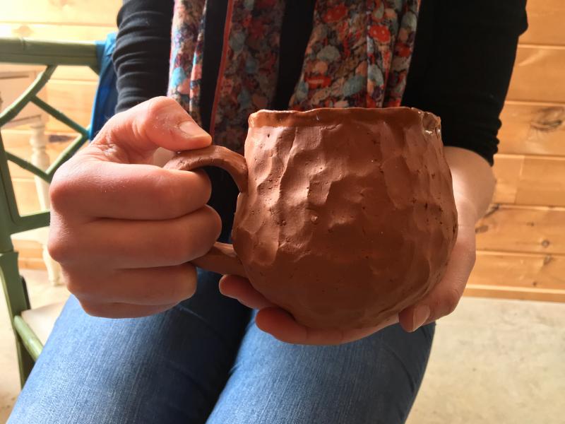 The photographs being taken for the book are close-ups of their interviewees’ hands holding their new cup, or mug. SUZI THAYER/Boothbay Register