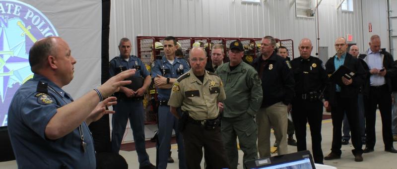 Lt. Mark Brooks, commanding officer of Troop C (Skowhegan) gives officers an update on the April 26 events with Lt. Col. John Cote and Somerset Sheriff Dale Lancaster in the background, among others. (Photo courtesy Maine Office of Public Safety)
