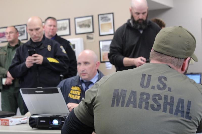 Officers from the state, county, municipal and federal ranks inside the command post, at the Norridgewock Fire Station. (Photo courtesy Maine Office of Public Safety)