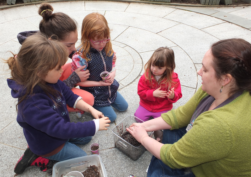 Loraine Murray mixes up a batch of seed-balls for the kids to form.
