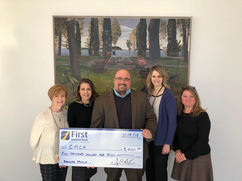 Gathered for a check presentation at CMCA are Susan Norton, EVP/Chief Administrative Officer at First National Bank; Suzette McAvoy, Director of CMCA; Jake Miller, VP/Senior Business Development and Corporate Sales Officer at First National Bank; Michelle Curtis, VP/Regional Manager at First National Bank; and Niki Janczura, Business Development Officer at First Advisors.