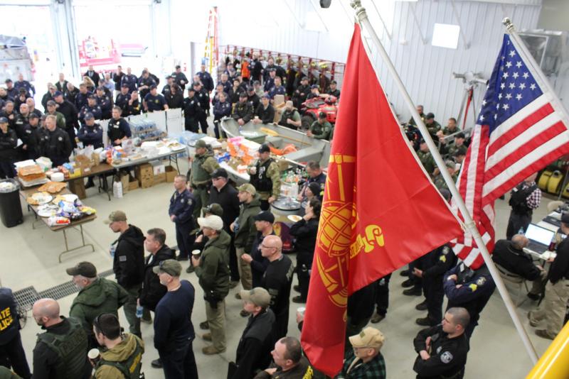 Some of the 200 officers from county, state, municipal and federal agencies at the April 26 briefing get their assignments while in the command post, at the Norridgewock Fire Station. (Photo courtesy Maine Office of Public Safety)