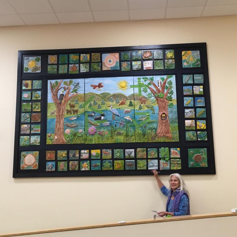 Randy Fein with finished ceramic relief mural. (Photo courtesy Randy Fein)
