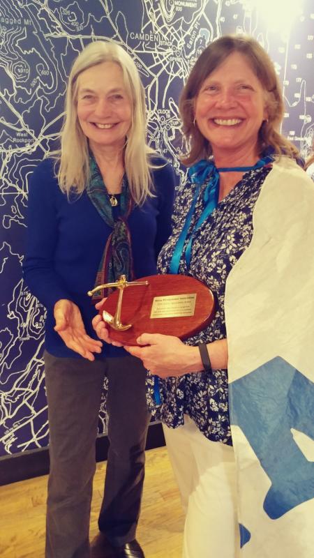 Meg Maiden is congratulated on receiving the 2018 Maine Windjammer Association Lifetime Appreciation Award by Captain Linda Lee of the Schooner Heritage. (Photo courtesy Marti Mayne/Maine Windjammer Association)