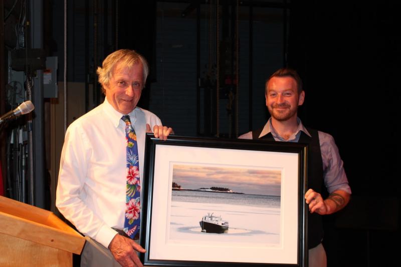 Rockport Town Manager Rick Bates presented outgoing Selectman Owen Casas with a framed photograph by Peter Ralston. (Photo courtesy of Marci Casas)