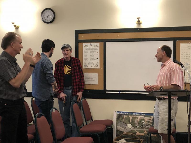 Mac Thomas, center, receives a standing ovation from the Camden community July 10 at the Camden Select Board meeting. (Photo by Lynda Clancy)